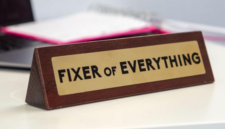 close up of fixer of everything desk plaque sign