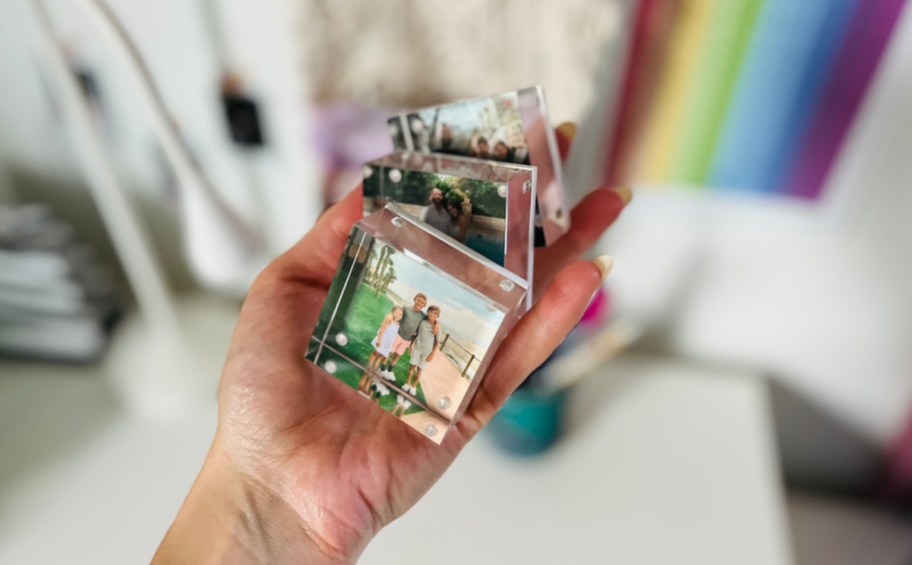 hand holding three acrylic photo blocks