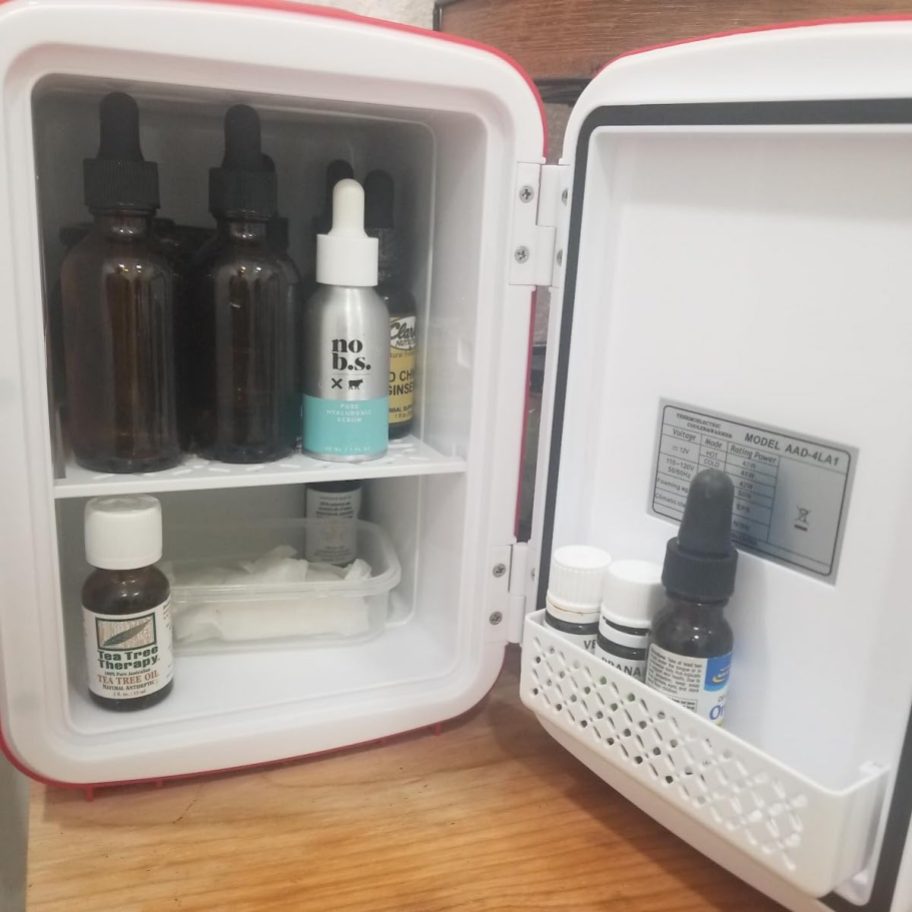 inside of mini fridge with skincare bottles inside