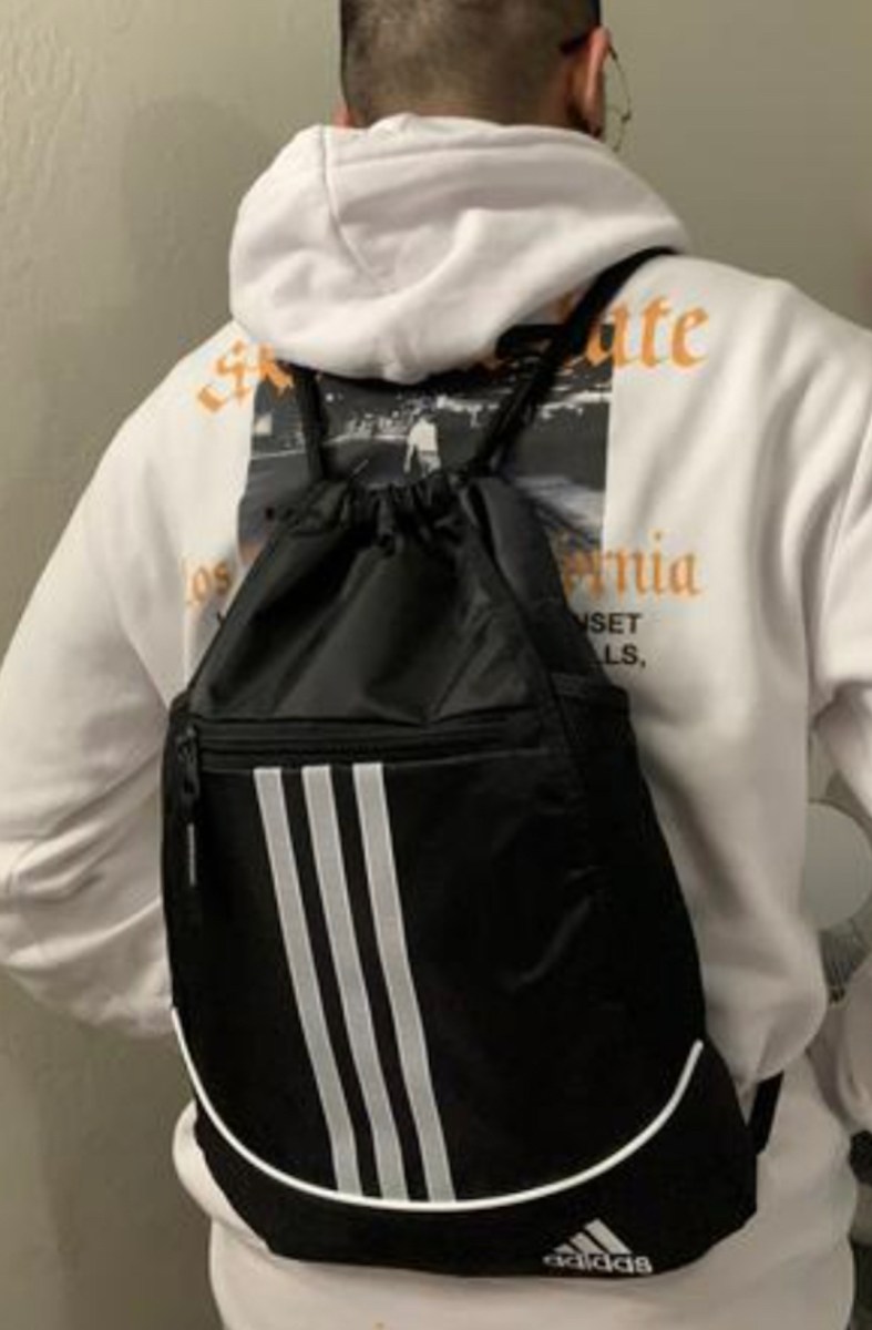 teen boy wearing adidas drawstring bag