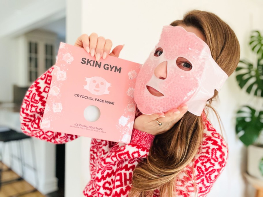 woman wearing an ice bead mask holding the packaging near her face