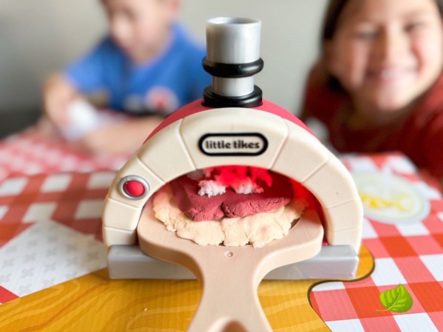 close up of sand pizza in little tikes plastic toy oven