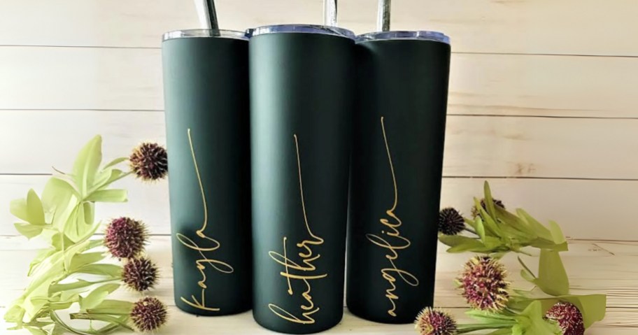 3 dark green tumblers with straws that have names on them in a gold cursive font