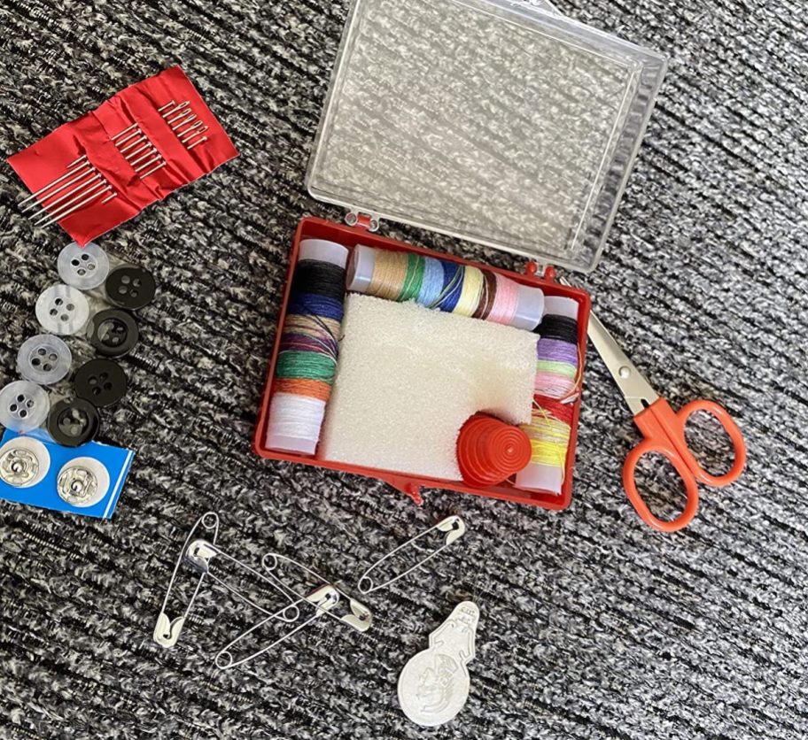 Mini sewing kit spread out on carpet 