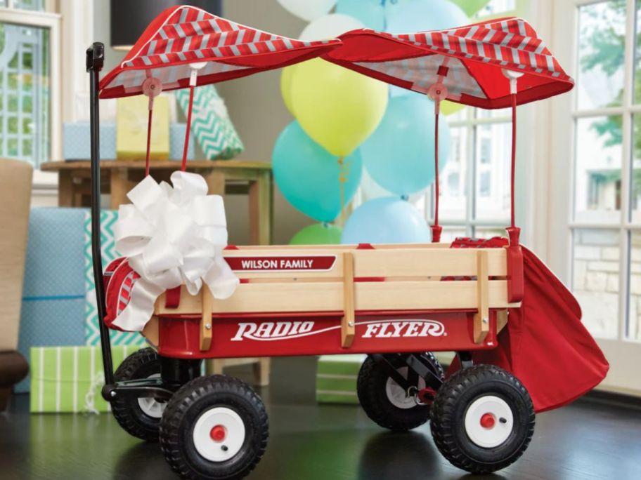 A Radio Flyer Wagon with a bow on it 