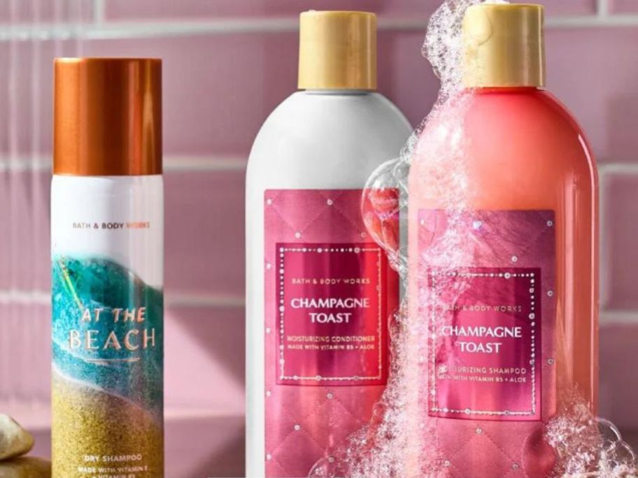 A bottle of Bath & Body Works Dry Shampoo next to bottles of Shampoo and Conditioner