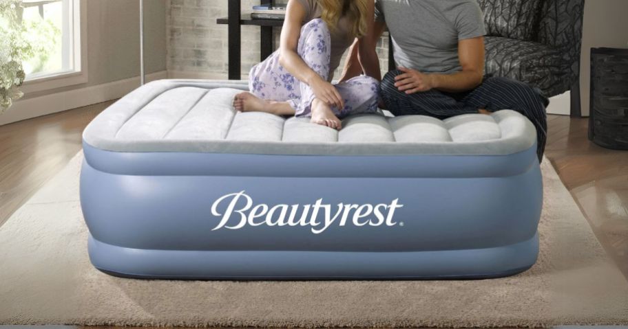 couple sitting on Beautyrest Hi Loft 17" Air Mattress w/ External Pump