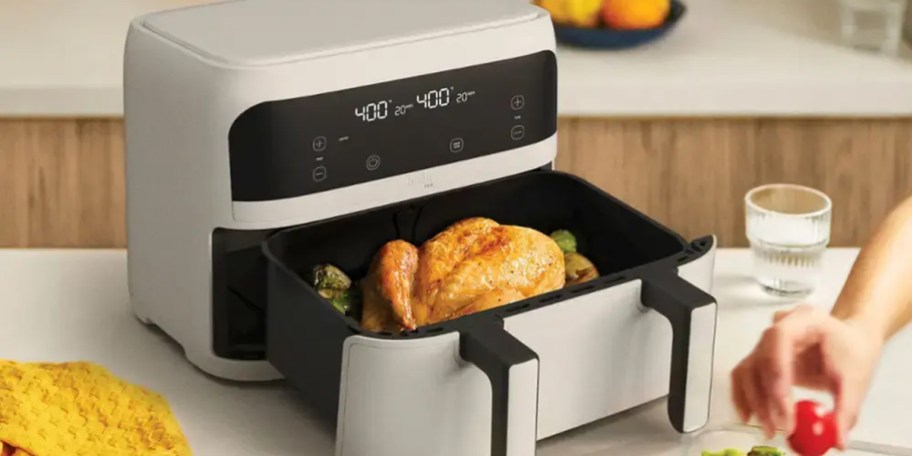 gray and black air fryer on table with chicken