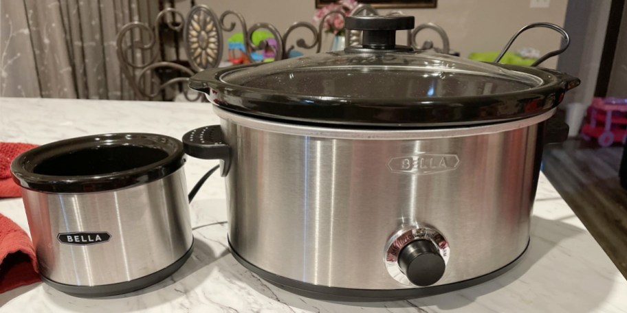 stainless steel slow cooker and dipper on table