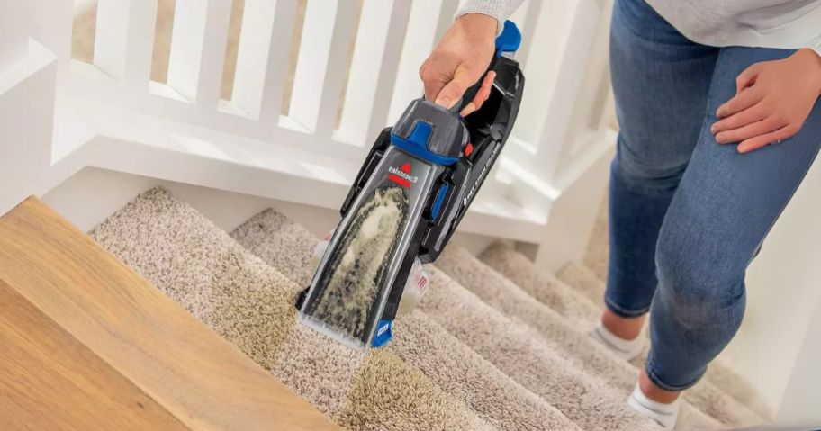 woman using Bissell Pet Stain Eraser on stairs