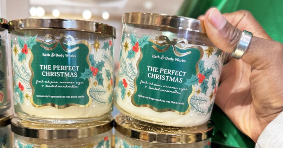 hand touching christmas Bath & Body Works 3-Wick Candles