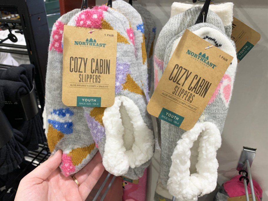 Northeast Outfitters Cozy Cabin Slippers hanging on store display