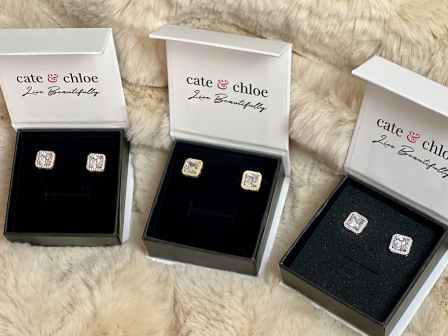 three boxes with square cut earrings in them 