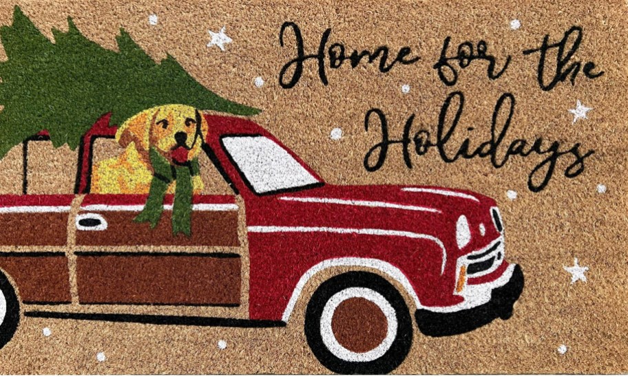 doormat printed with red station wagon with dog inside and tree on top and says "home for the holidays"