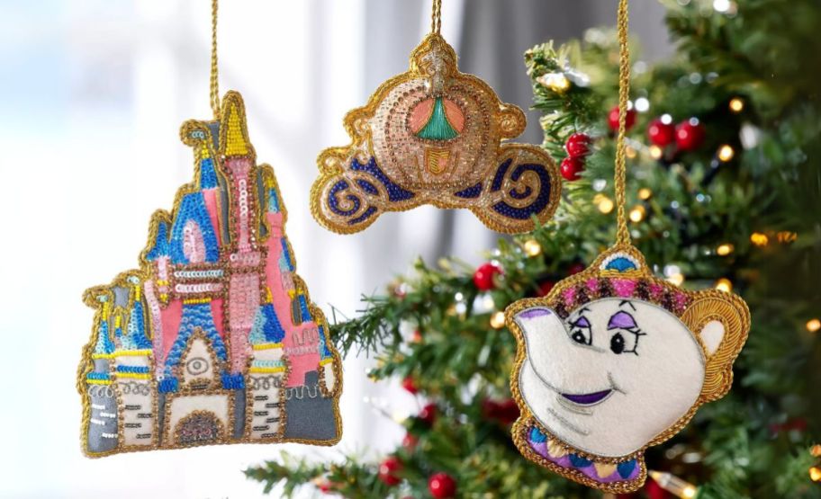 3 disney ornaments hanging in a tree