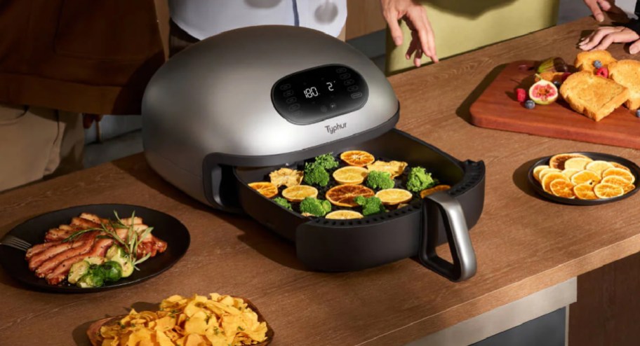 Typhur Dome air fryer with food inside and around it