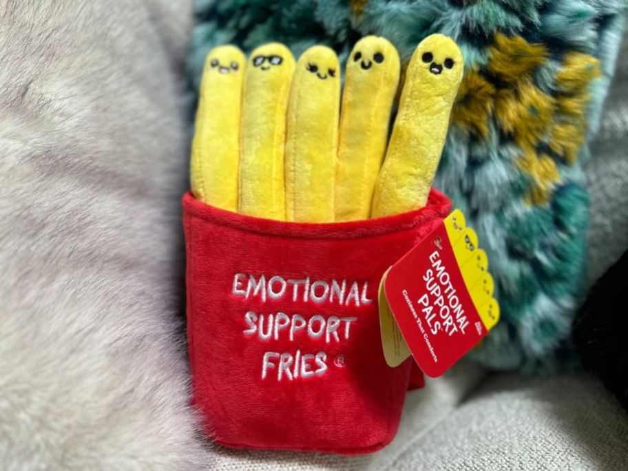 Emotional Support Plush Fries amongst pillows