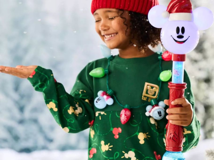 Child with a Mickey Mouse Light and Sound Holiday Snow Wand