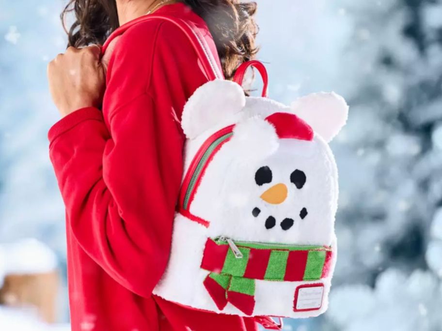 Woman wearing a Disney Loungefly Snowman Backpack