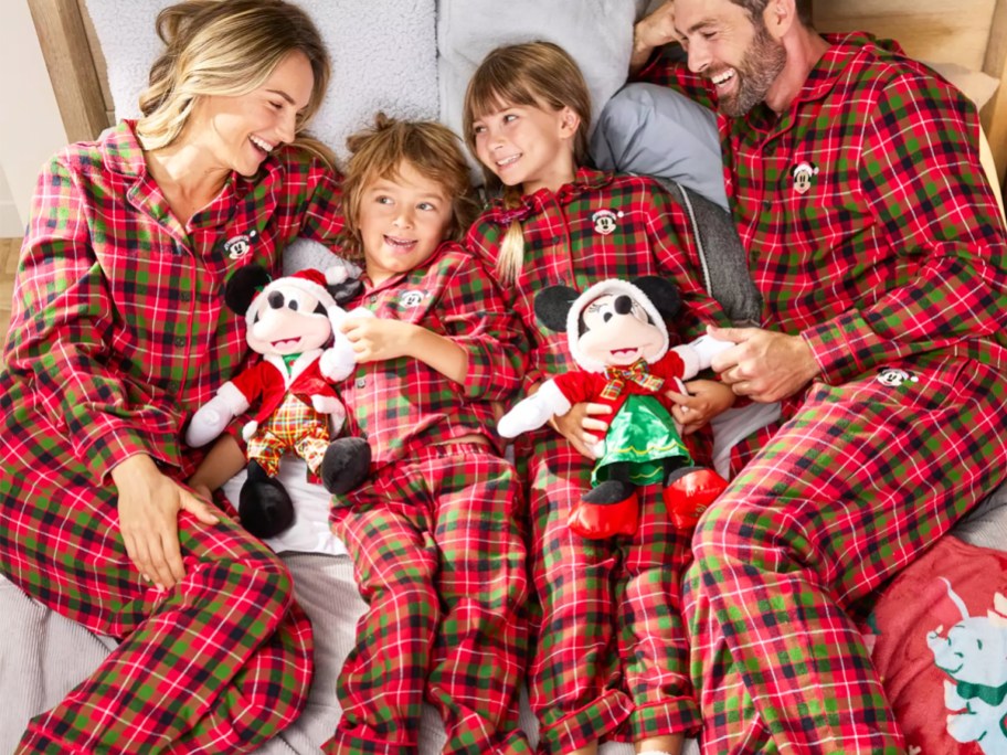 family wearing matching disney holiday pajamas