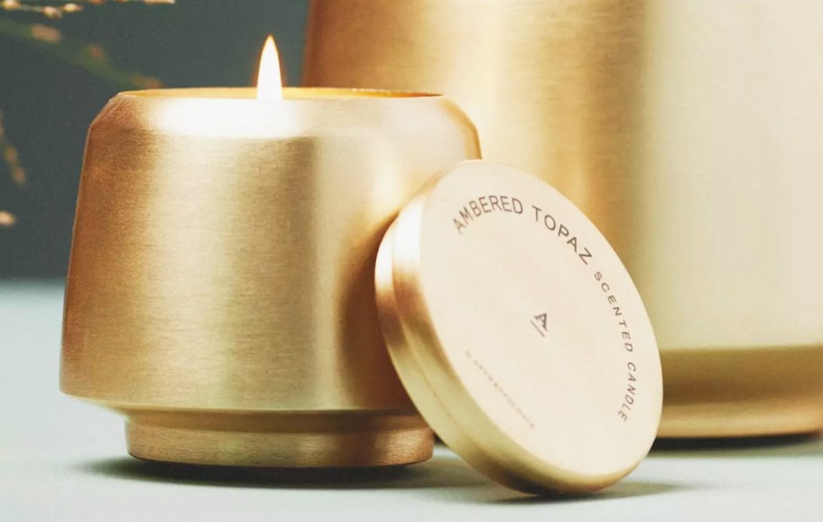 lit gold metal jar candle