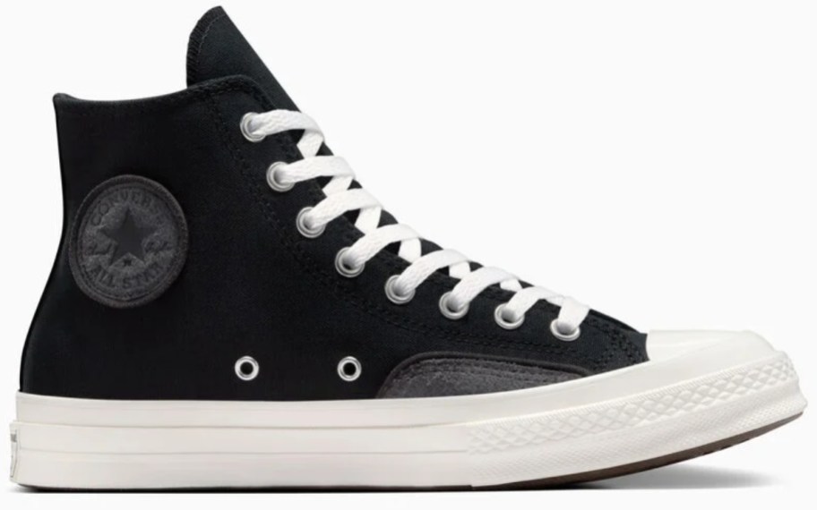 an adults Converse Chuck Taylor high top shoe in solid black with a white sole