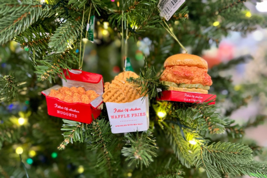 three kurt adler chick fil a inspired Christmas ornaments on a tree in a kohls store