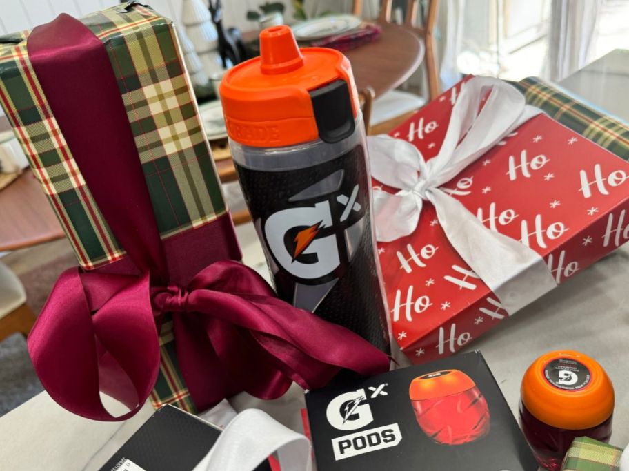 Gatorade GX Bottle and pods surrounded by holiday gift wrapped boxes