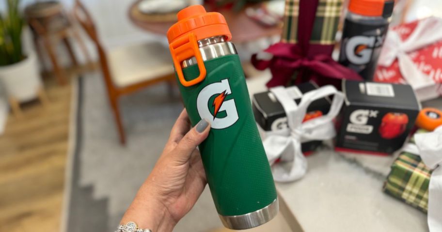 Hand holding a gatorade stainless steel water bottle