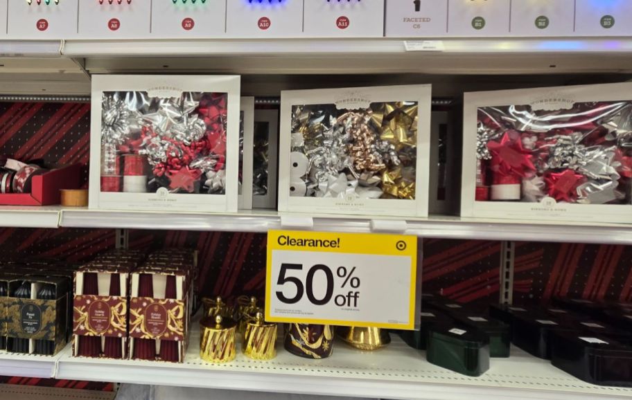 holiday gift wrap kits and holiday decor on a store shelf