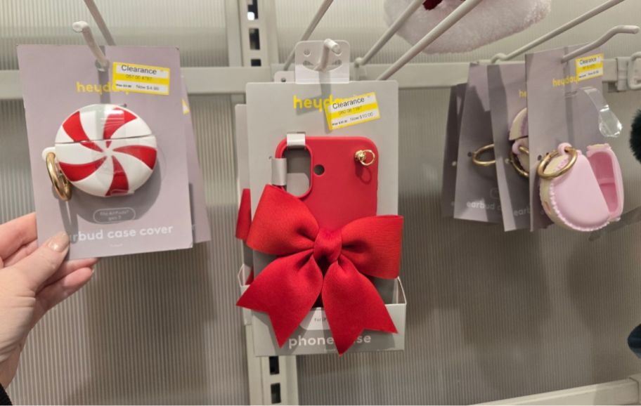 holiday phone cases and accessories on a peg board on a store shelf