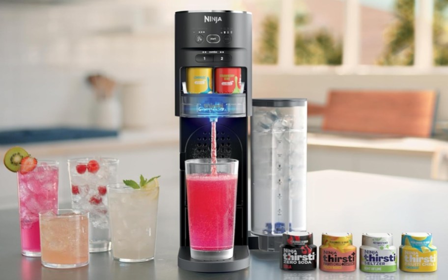 ninja thirsti drink system on counter with cups and water drop packs