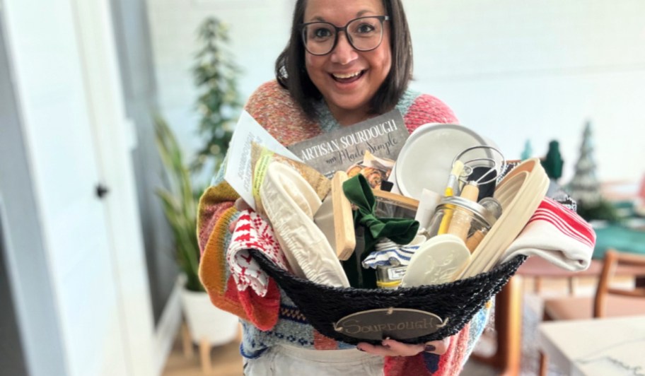 woman holding a sourdough gift basket for christmas