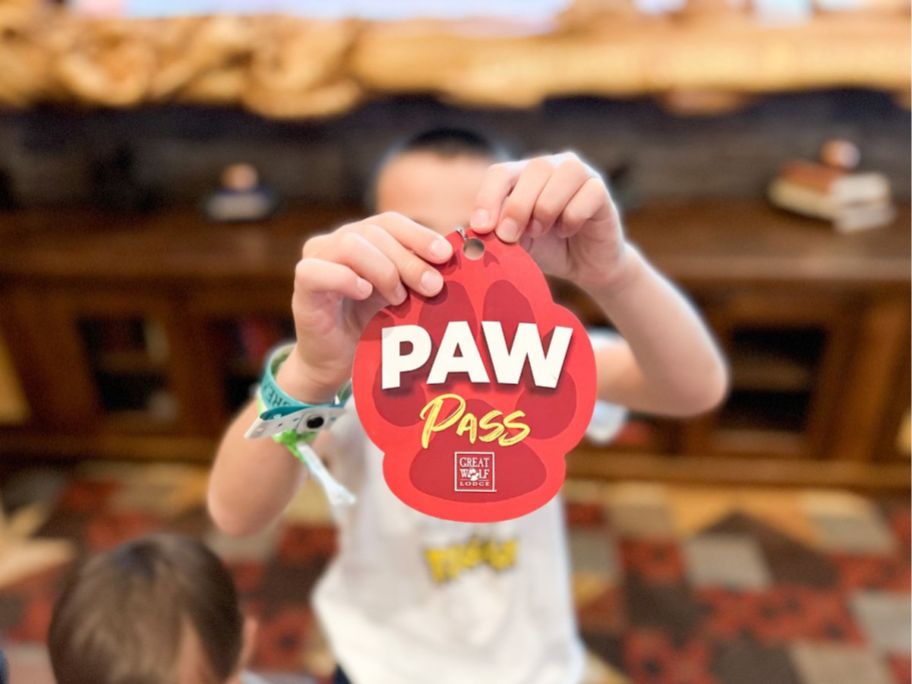 boy holding up Great Wolf Paw Pass