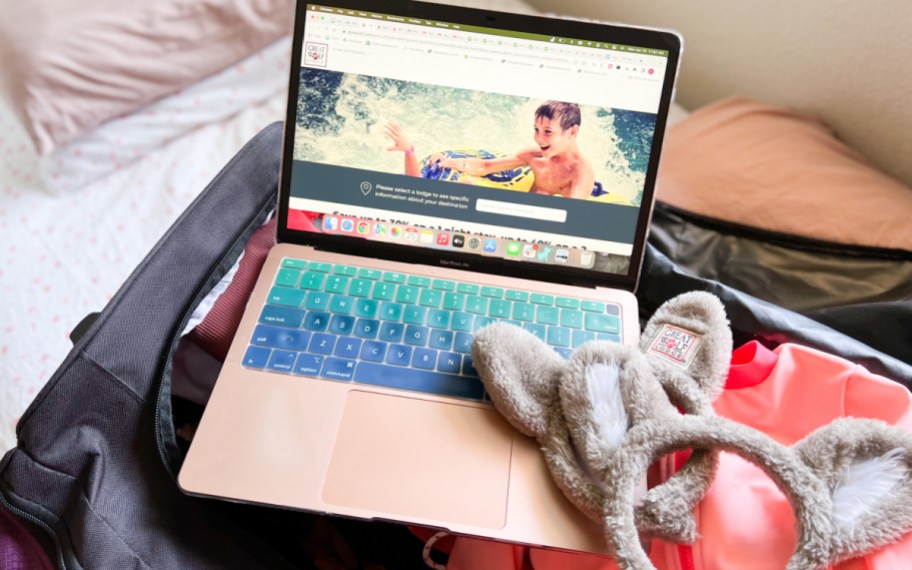 laptop with great wolf lodge on the screen sitting on luggage