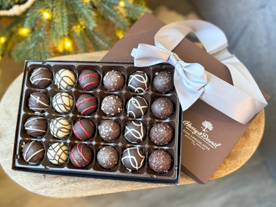 open box of Harry & David Chocolate Truffles, with the box lid and ribbon partly under it