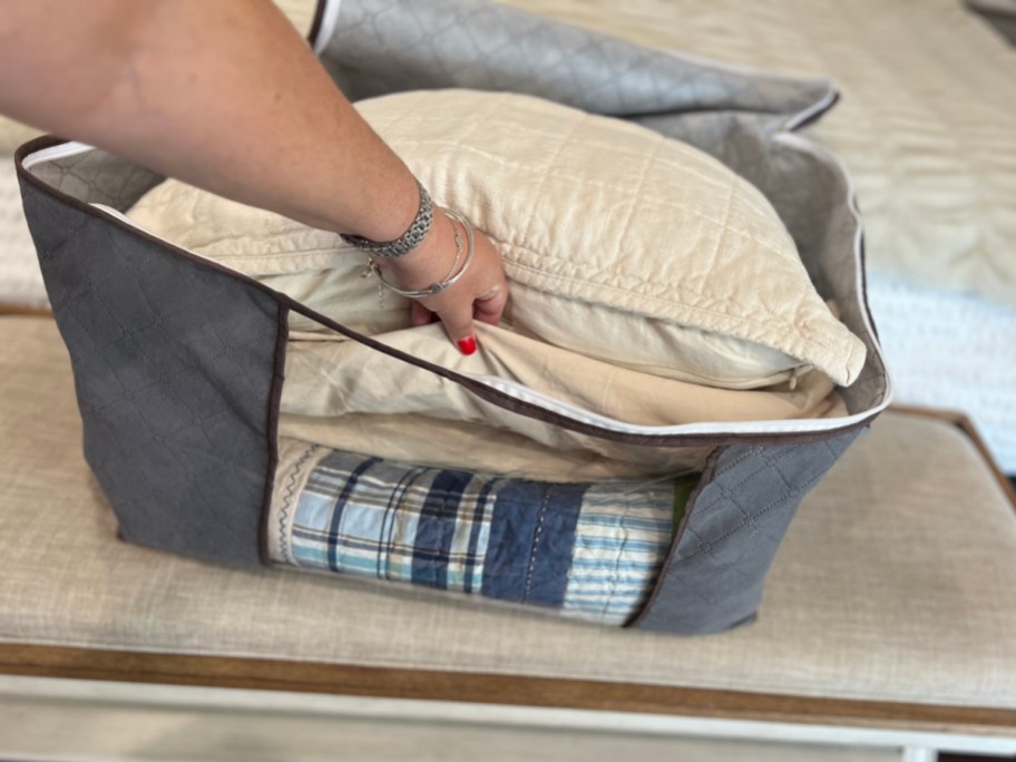 bedding in a foldable grey tote bag