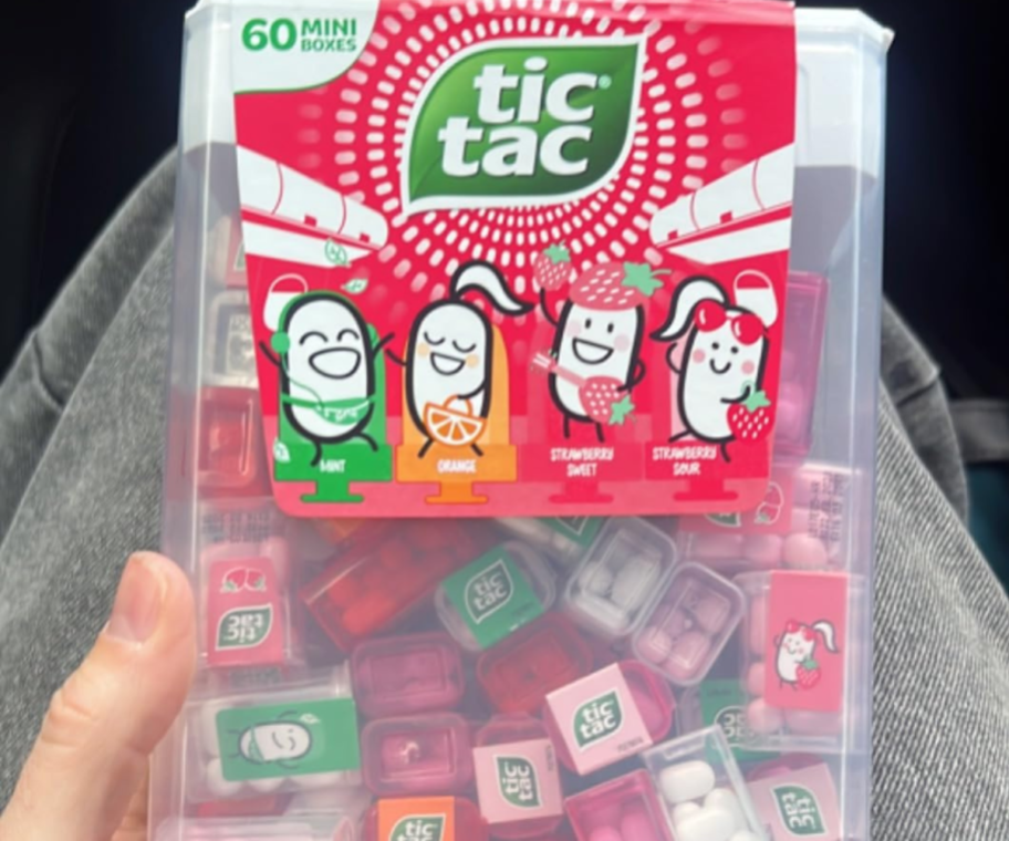 A person holding a giant Tic Tac Strawberry Edition box