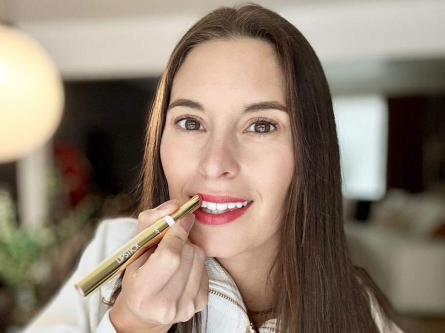 woman applying red Tarte Maracuja Juicy Lipstick