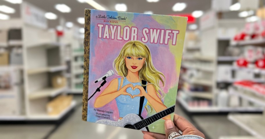 hand holding a Taylor Swift Little Golden Book in a store aisle