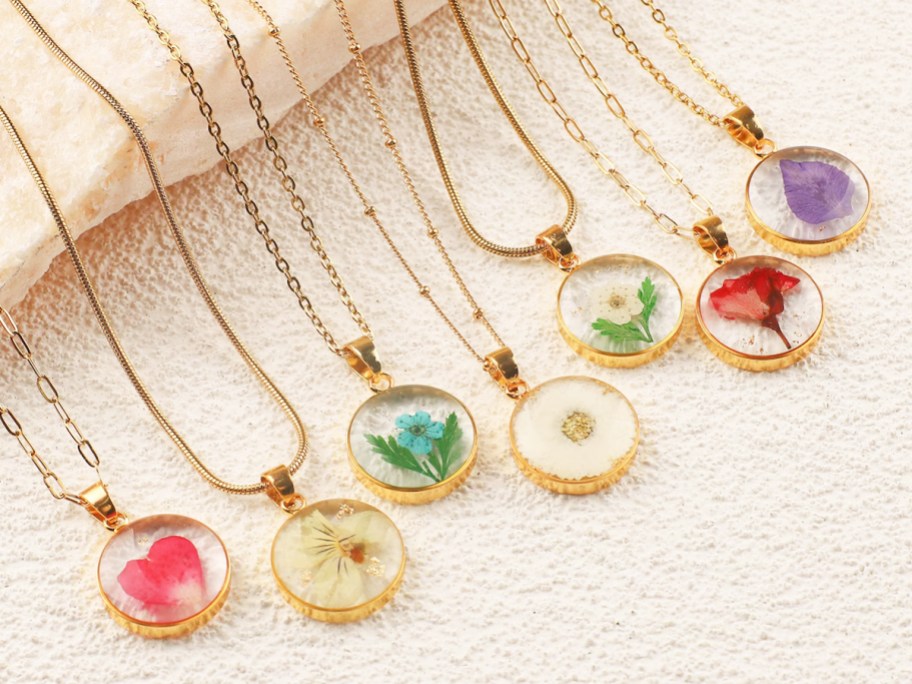 colorful flower necklaces on gold chains