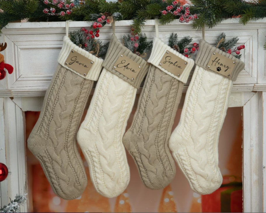 white and tan personzlied stockings hanging on mantle