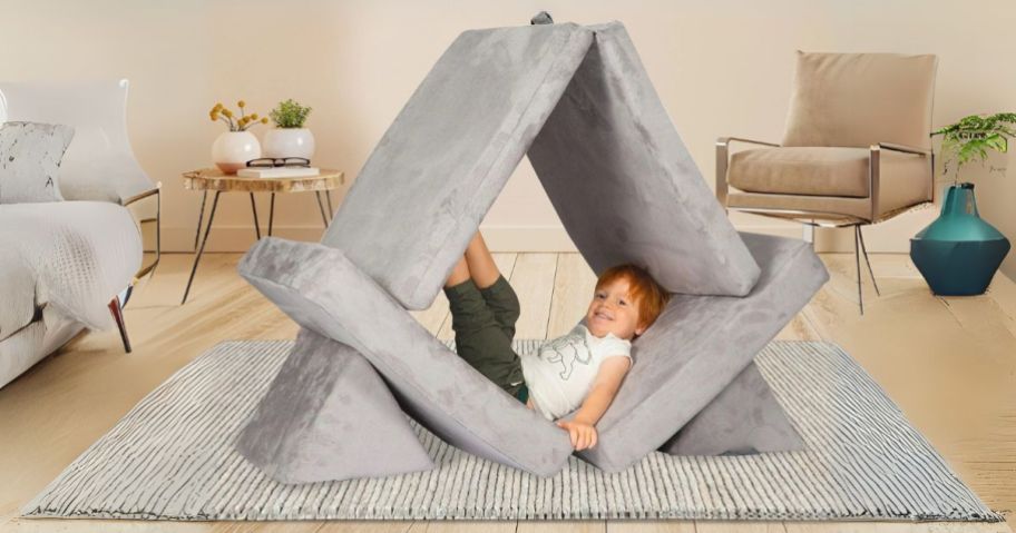 kid laying on Huddle Kids Couch in living room