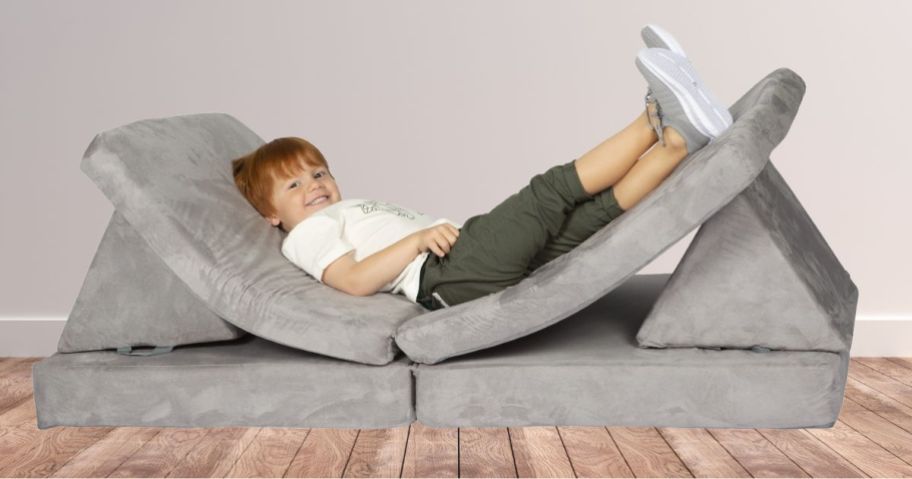 kid laying on Huddle Kids Couch in living room