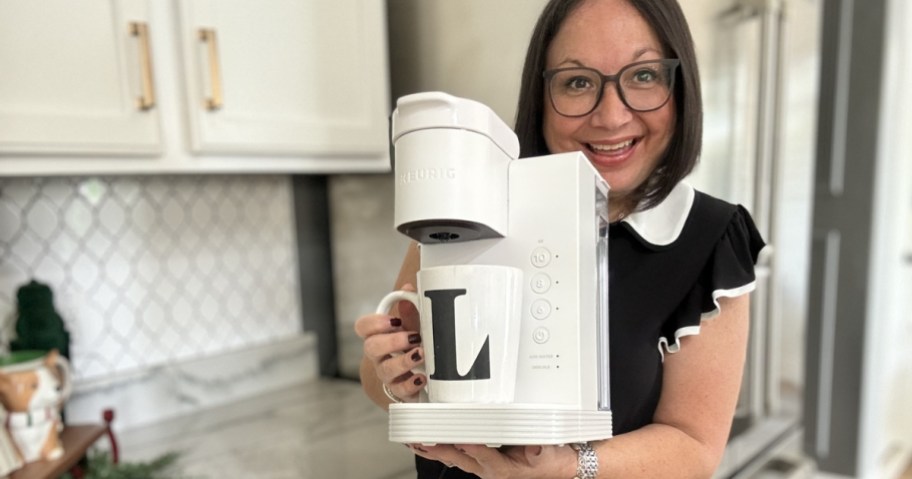 woman holding keurig k-express coffee maker