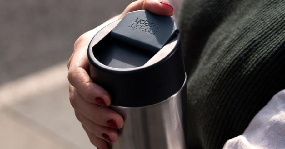 hands holding a Jospeh Jospeh Travel Tumbler