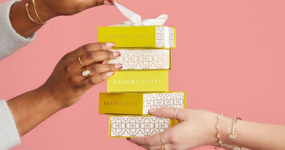 hands holding kendra scott gift boxes