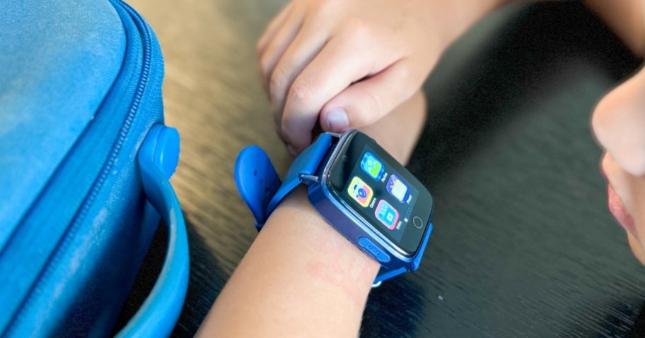 boy wearing a blue and black smartwatch on his wrist