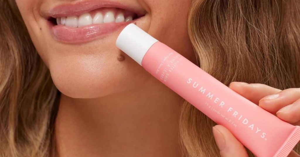 woman holding pink Summer Friday Lip Balm