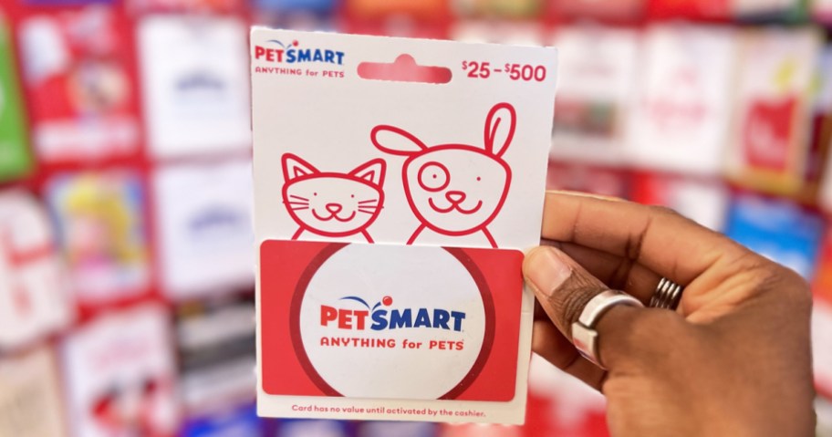 hand holding petsmart gift card in store